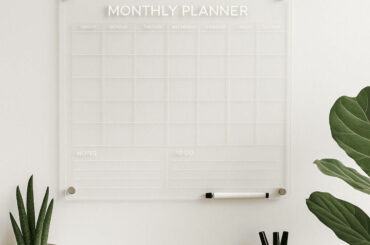 Minimalist home office featuring a clear acrylic monthly planner on the wall, ideal for those wondering when to use acrylic planners for better organisation.
