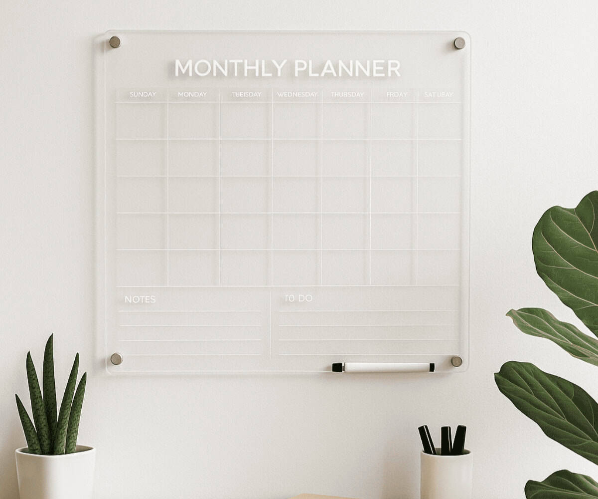 Minimalist home office featuring a clear acrylic monthly planner on the wall, ideal for those wondering when to use acrylic planners for better organisation.