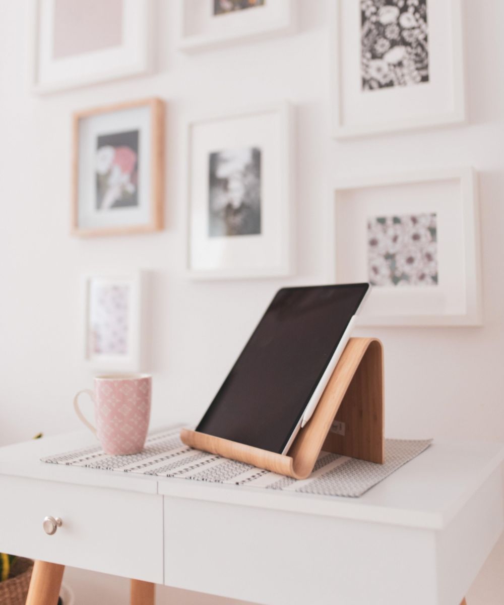 Gallery wall of picture frames in a home with tablet used to buy picture frames online