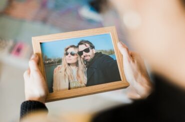 Person holding a custom picture frame with a photo inside