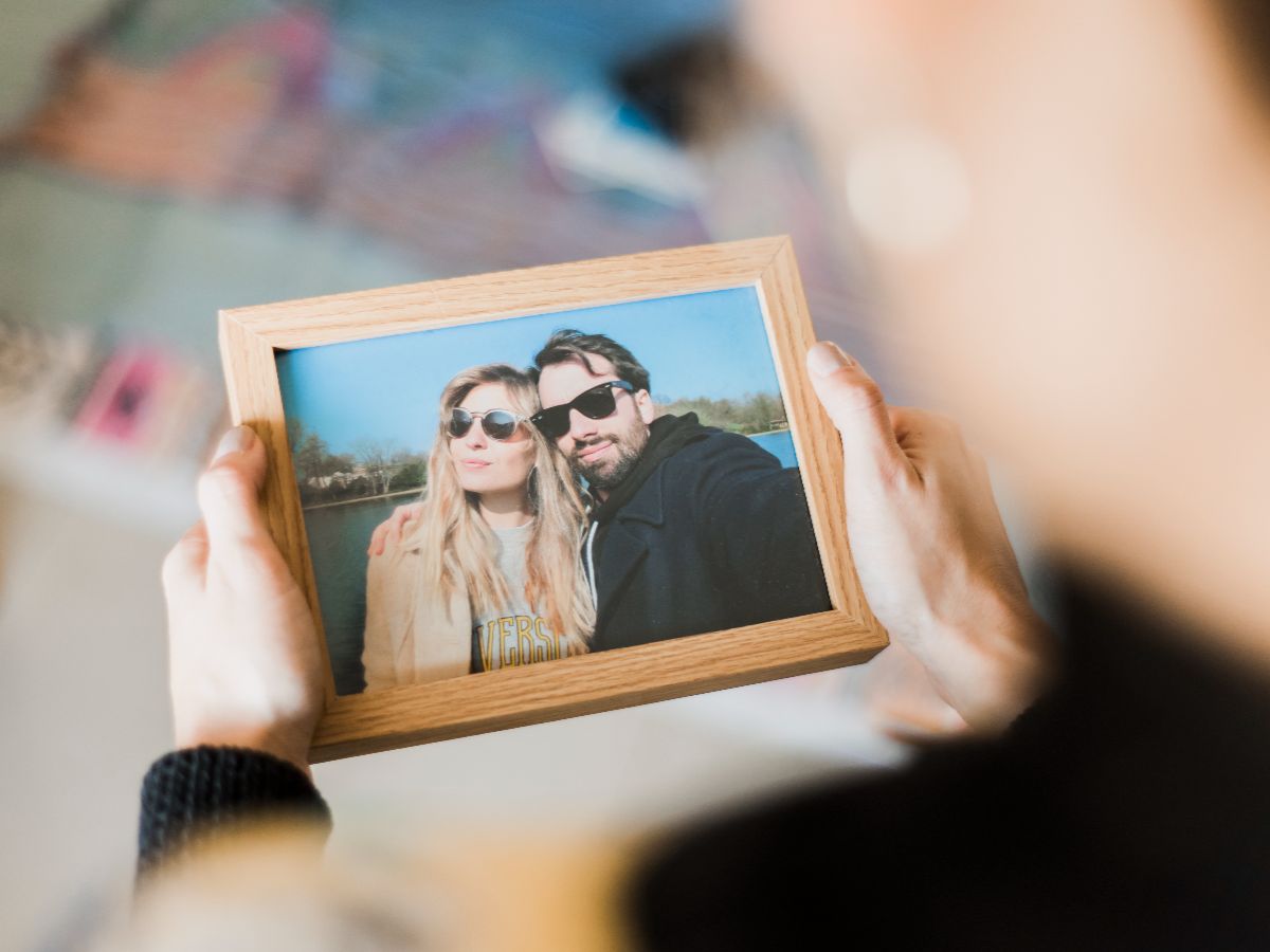 Person holding a custom picture frame with a photo inside