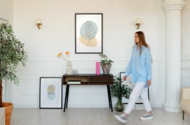 Custom picture frames used to style artwork in a modern living room